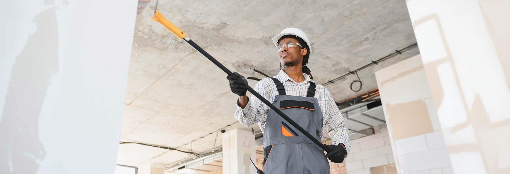 man painting wall in office